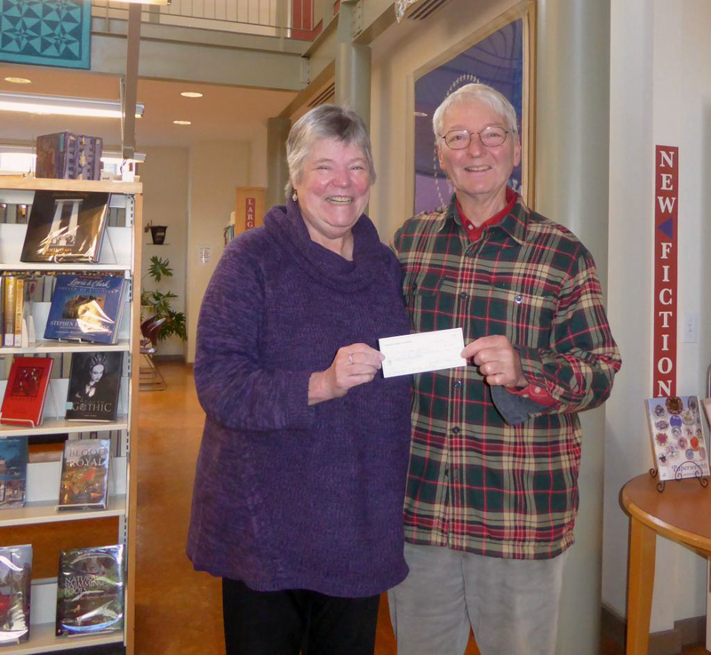 Skidompha Library Executive Director Pam Gormley receives a check for renewal of a museum pass to the Portland Museum of Art from Paul Sherman, vice president of the Pemaquid Group of Artists.