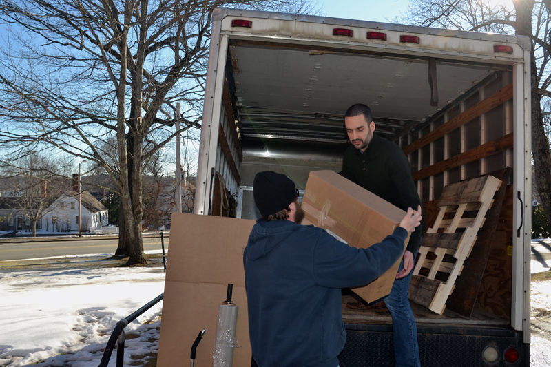 Lincoln County Publishing Co. employees Graham Burnham (left) and J.W. Oliver load a truck with newspaper archives outside the Lincoln County Courthouse in Wiscasset on Friday, Jan. 25. (Maia Zewert photo)