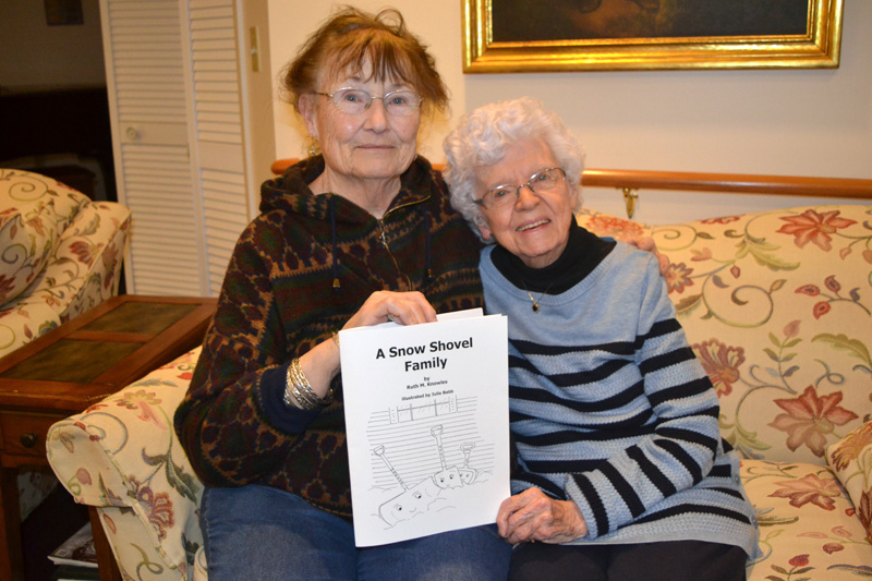 Damariscotta artist Julie Babb (left) and Newcastle writer Ruth Knowles with Knowles' new children's book, "A Snow Shovel Family," illustrated by Babb. (Christine LaPado-Breglia photo)