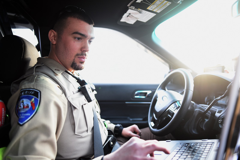 Lincoln County Sheriff's Deputy Chase Bosse works on the computer in his cruiser Thursday, Jan. 10. (Jessica Picard photo)