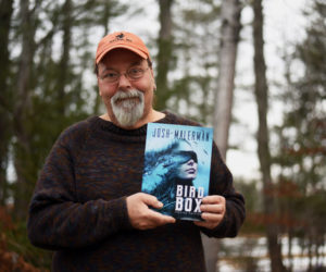 Newcastle artist Glenn Chadbourne holds a special edition of the book "Bird Box" by Josh Malerman, which he illustrated. A Netflix movie based on the book has become the streaming service's most-watched original film ever. (Jessica Picard photo)