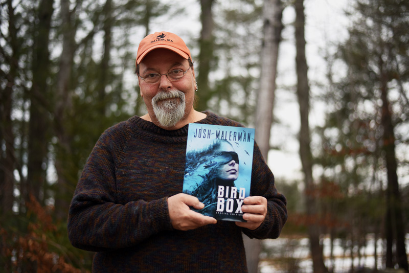 Newcastle artist Glenn Chadbourne holds a special edition of the book "Bird Box" by Josh Malerman, which he illustrated. A Netflix movie based on the book has become the streaming service's most-watched original film ever. (Jessica Picard photo)