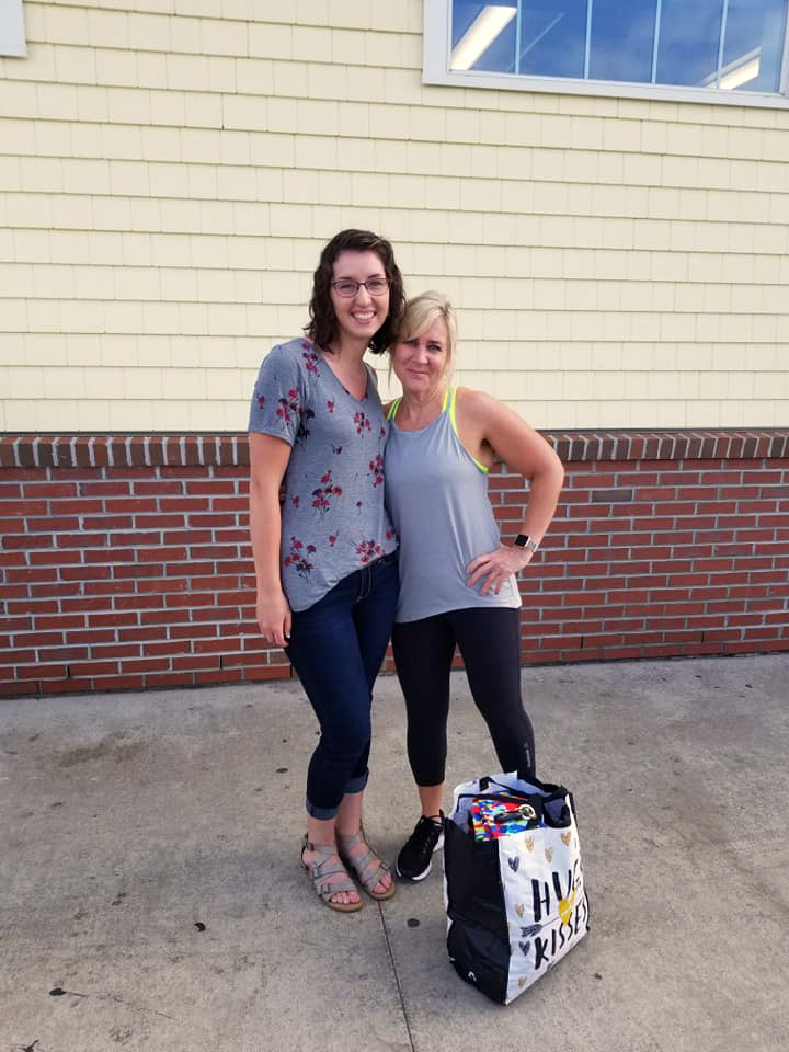 Erica St. Peter (left) presents a donation of weighted lap pads to Julie Nickerson, a first-grade teacher at the Dedham School in Dedham. (Photo courtesy Erica St. Peter)