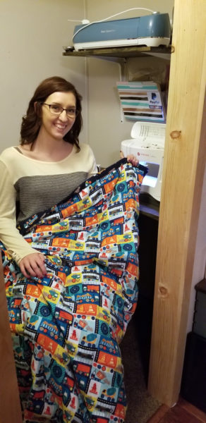 Erica St. Peter, owner of St. Peter Sew Sweet Creations, holds one of her weighted blankets. (Photo courtesy Erica St. Peter)