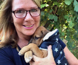 Caroline Canning, a part-time resident of Westport Island, holds a puppy she rescued in Costa Rica. She will fly the puppy to Burlington, Vt., to find him a permanent home, at the end of January. (Photo courtesy Caroline Canning)