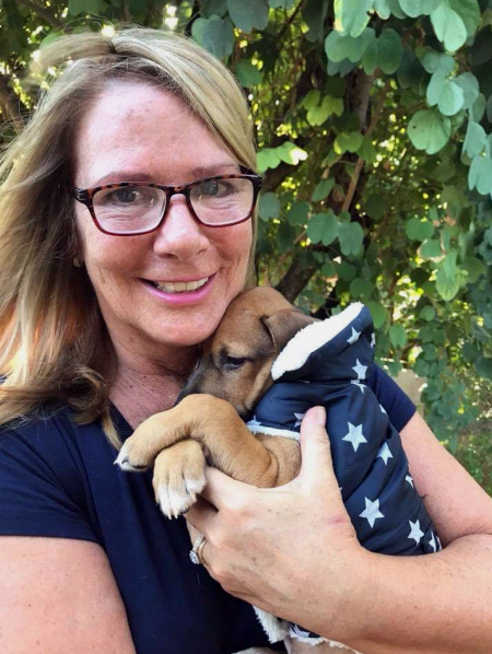 Caroline Canning, a part-time resident of Westport Island, holds a puppy she rescued in Costa Rica. She will fly the puppy to Burlington, Vt., to find him a permanent home, at the end of January. (Photo courtesy Caroline Canning)