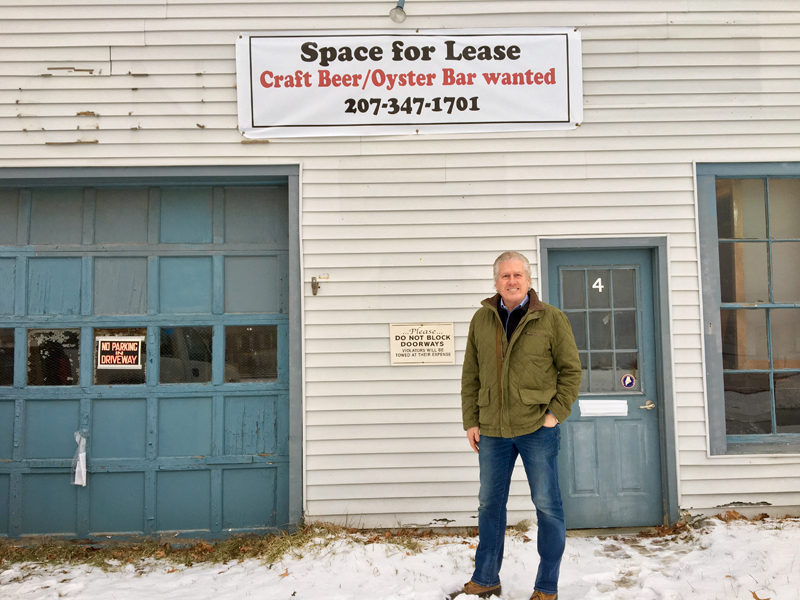 Craig Winslow stands in front of the Railroad Avenue side of his new building at 4 Railroad Ave. and 51 Water St. in downtown Wiscasset. (Suzi Thayer photo)