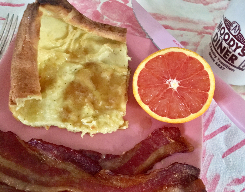 Swedish pancakes with butter (more butter) and maple syrup, served with bacon and an orange (to make it healthy). :-) (Suzi Thayer photo)