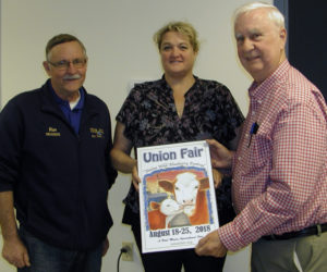 From left: Union Fair/Maine Wild Blueberry Festival President Ron Hawes, 2018 Union Fair poster contest winner Gail Hawes, and poster contest chair George Gross display the 2018 Union Fair poster (Photo courtesy Union Fair)