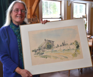 Julia Lane, daughter of the late Lincoln County sculptor Cabot Lyford, poses with one of her father's watercolor paintings at her Round Pond home Jan. 23. (Christine LaPado-Breglia photo)
