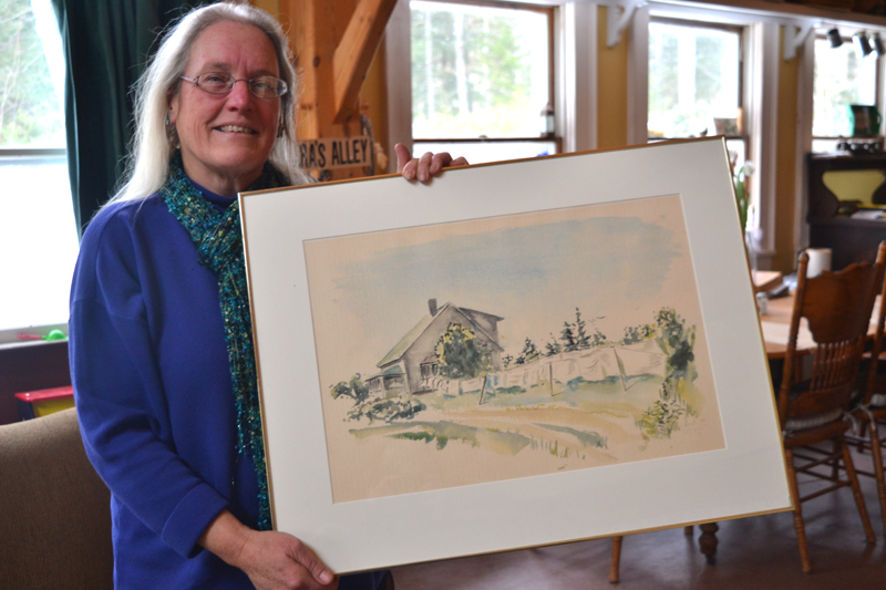 Julia Lane, daughter of the late Lincoln County sculptor Cabot Lyford, poses with one of her father's watercolor paintings at her Round Pond home Jan. 23. (Christine LaPado-Breglia photo)