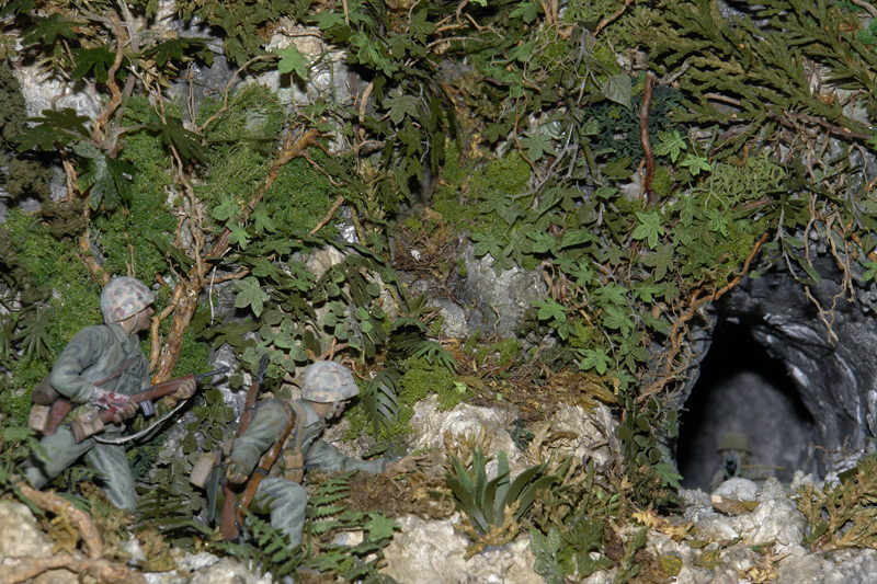 U.S. Marines, one with a grenade in hand, approach a Japanese machine gunner in a cave on Peleliu in a World War II diorama by Ed Strausberg. (Jack Lane photo/courtesy Ed Strausberg)