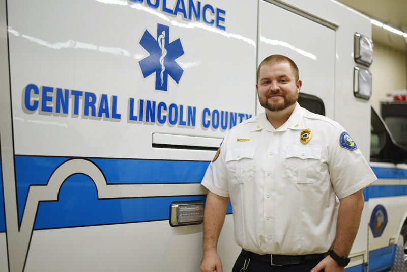 Central Lincoln County Ambulance Service Chief Nicholas Bryant stands in front of an ambulance Friday, Feb. 8. Bryant started work in his new position Feb. 5. (Jessica Picard photo)