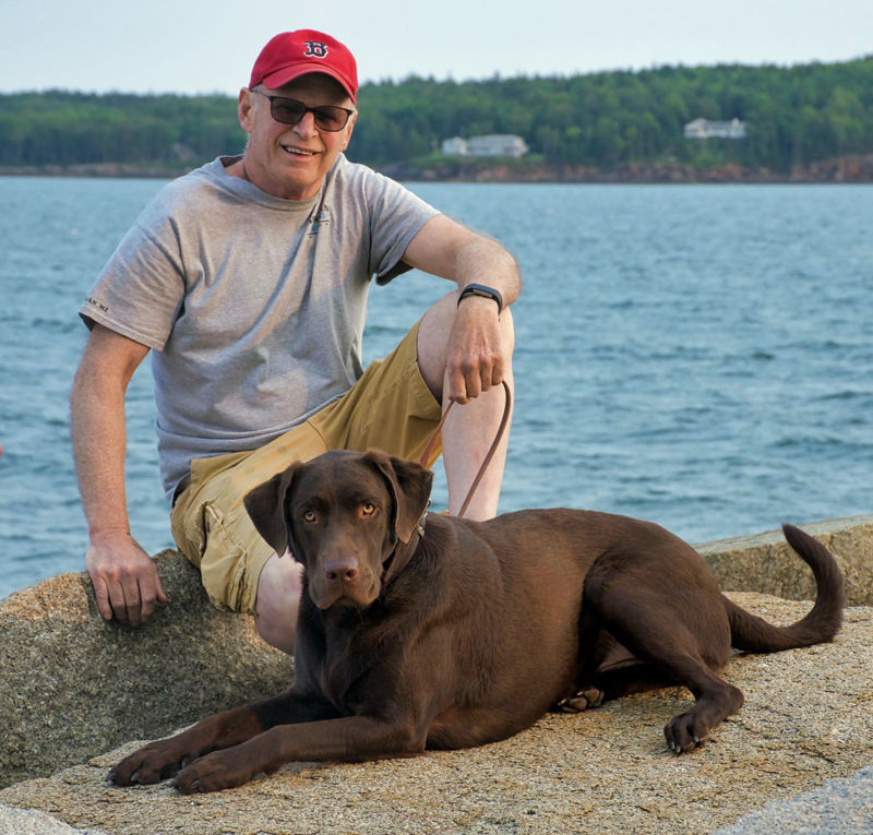 Kenny Ames and his chocolate Lab, Finn.