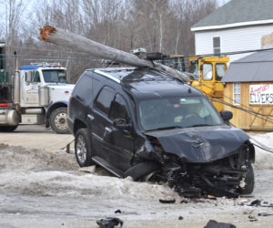 A utility pole rests atop a GMC Yukon Denali SUV after a two-vehicle collision on Route 1 in Waldoboro the morning of Tuesday, Feb. 12. There were no injuries in the crash, according to police. (Alexander Violo photo)