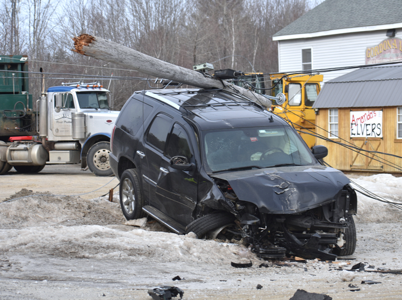 A utility pole rests atop a GMC Yukon Denali SUV after a two-vehicle collision on Route 1 in Waldoboro the morning of Tuesday, Feb. 12. There were no injuries in the crash, according to police. (Alexander Violo photo)