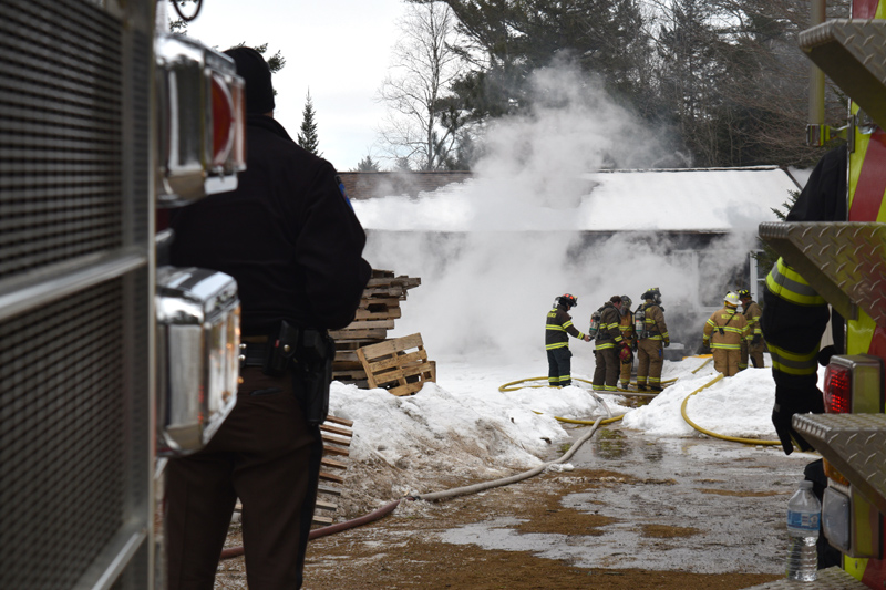 Firefighters work at the scene of a house fire at 48 Greenleaf Road on Westport Island. (Jessica Clifford photo)