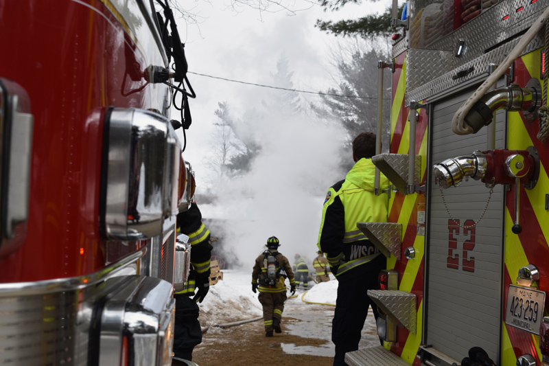 A firefigher walks toward a home on fire at 48 Greenleaf Road in Westport Island. (Jessica Clifford photo)