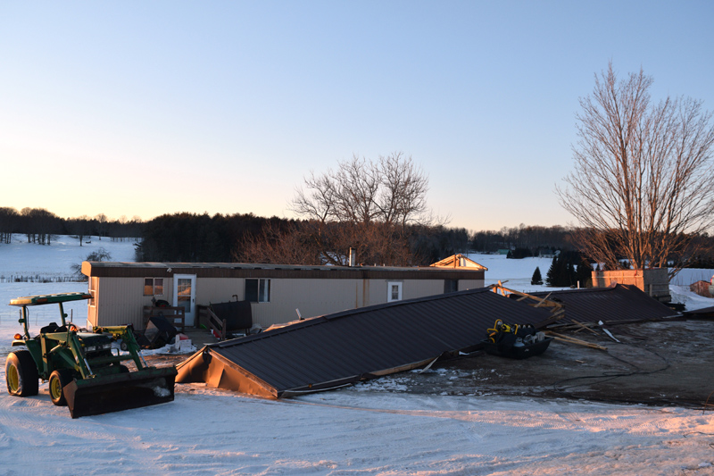 The metal roof of a mobile home at 45 Townhouse Road in Whitefield lies on the ground in front of the home Tuesday, Feb. 26 after blowing off during high winds the previous night. (Jessica Clifford photo)