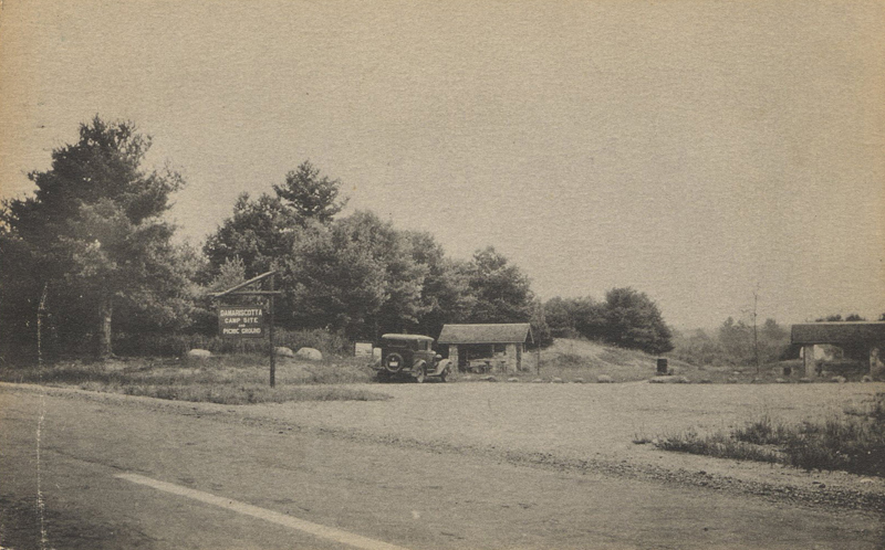 A photo postcard of the Damariscotta picnic and camp area with covered picnic tables and stone fireplaces. This is the area where one drives into the rifle club's road and is now being cut off and cleared. (Postcard from Marjorie and Calvin Dodge collection)