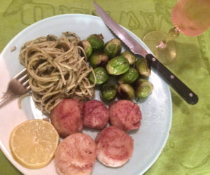 Pan-fried Maine scallops, pasta with pesto, and pan-roasted Brussels sprouts, with an elegant glass of Three-Buck Chuck. (Suzi Thayer photo)