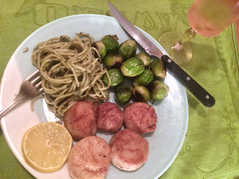 Pan-fried Maine scallops, pasta with pesto, and pan-roasted Brussels sprouts, with an elegant glass of Three-Buck Chuck. (Suzi Thayer photo)