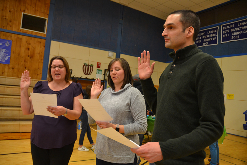 From left: Newly elected Bristol Selectman Kristine Poland and Bristol School Committee members Jessica DiMauro and J.W. Oliver take the oath of office after the annual town meeting at Bristol Consolidated School the evening of Tuesday, March 19. (Maia Zewert photo)