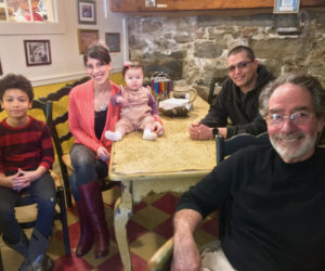 Bernie DeLisle (right) in his restaurant, Osteria Bucci, with the Que Rico family, from left: Dawson, Sarah McKenzie, Bella, and Michael Castillo. (Suzi Thayer photo)