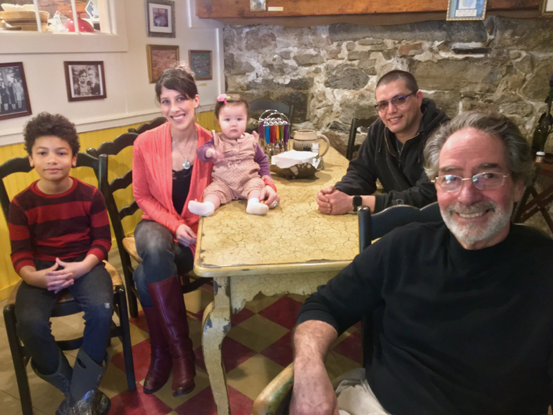 Bernie DeLisle (right) in his restaurant, Osteria Bucci, with the Que Rico family, from left: Dawson, Sarah McKenzie, Bella, and Michael Castillo. (Suzi Thayer photo)