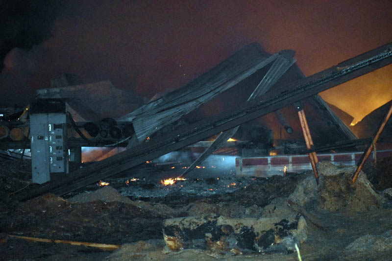 Flames are visible under debris at N.C. Hunt Lumber in Jefferson early Saturday, March 30. (Alexander Violo photo)