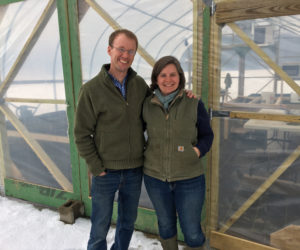 Mark and Sarah Lutte in front of their new greenhouse at Lazy Acres Farm. (Suzi Thayer photo)