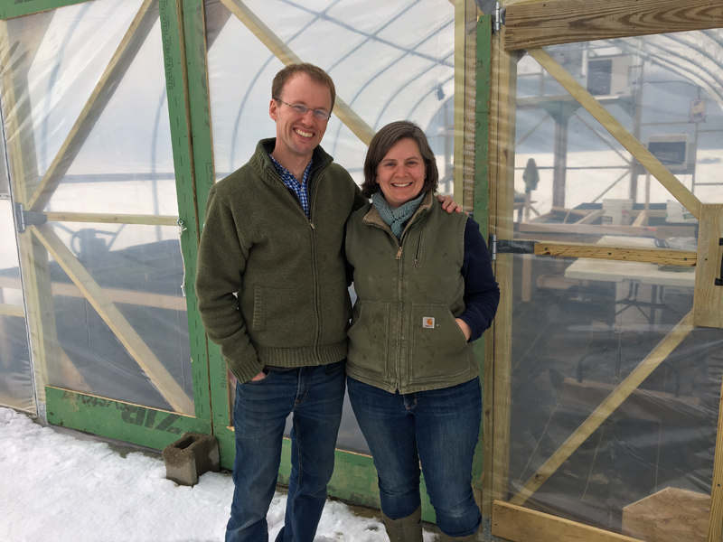 Mark and Sarah Lutte in front of their new greenhouse at Lazy Acres Farm. (Suzi Thayer photo)