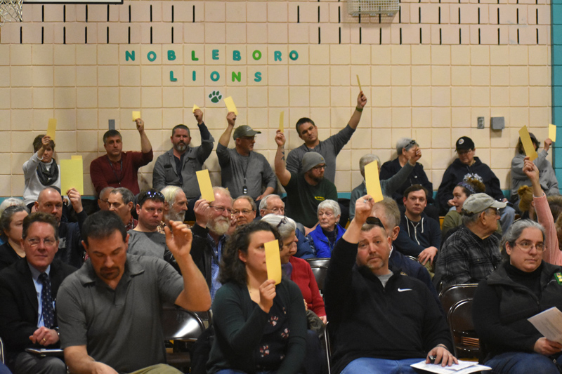 Nobleboro residents vote on an article during town meeting in the Nobleboro Central School gym the morning of Saturday, March 16. (Alexander Violo photo)