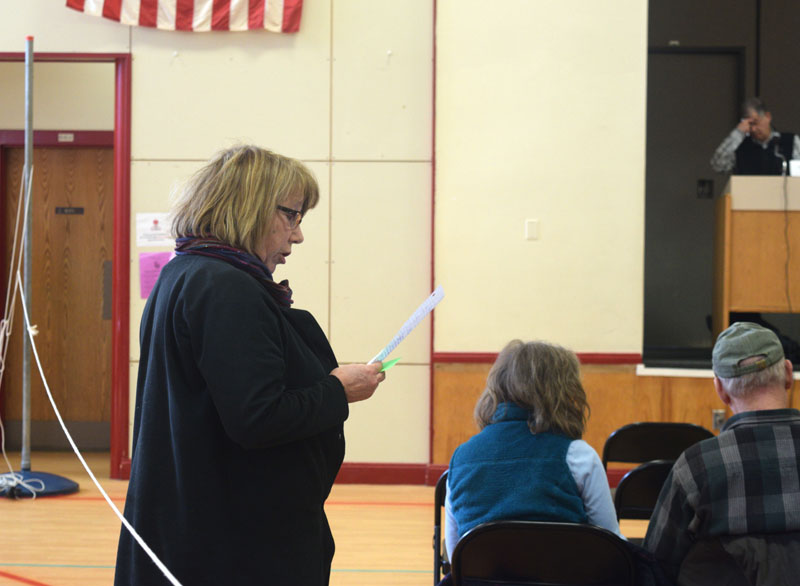 Whitefield resident Robin Chase reads a statement in opposition to a local food sovereignty ordinance at town meeting, Saturday, March 16. (Jessica Clifford photo)