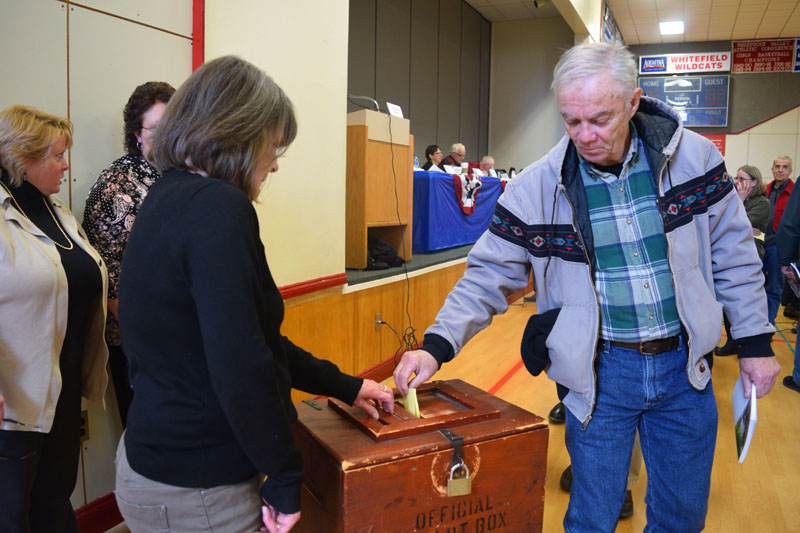 Whitefield resident Mike McMorrow places his ballot in the box during annual town meeting, Saturday, March 16. (Jessica Clifford photo)