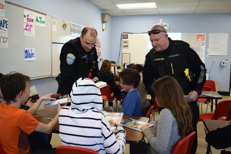 From left: Wiscasset School Resource Officer Cory Hubert and Wiscasset Police Chief Larry Hesseltine hand out name tags to fifth-graders during the first day of a D.A.R.E. class at Wiscasset Elementary School on Thursday, Feb. 28. (Jessica Clifford photo)