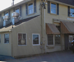 An architect for the new owner of the former Le Garage aims to conceal condensing units on the lower roof of the building's Main Street side. The Wiscasset Historic Preservation Commission is reviewing an application for these and other changes to the building's exterior. (Charlotte Boynton photo)