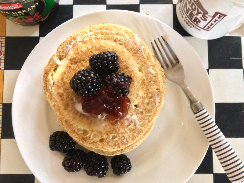 Ployes slathered with butter, a little jam, and some blackberries, with a cup of coffee, make for an awesome breakfast. (Suzi Thayer photo)