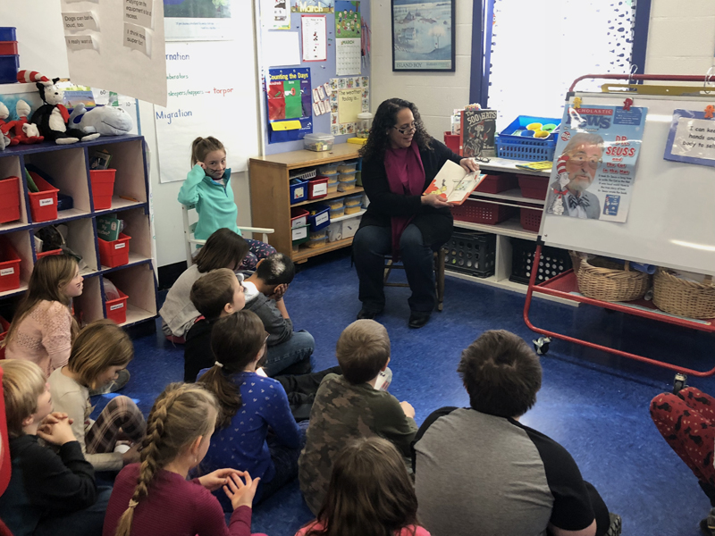 Larissa Darcy, of Bar Harbor Bank & Trust, shares a story with students in Wiscasset.