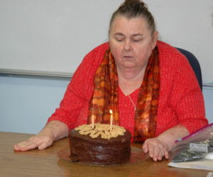 Somerville Third Selectman Darlene Landry blows out the candles on her birthday cake at the end of a selectmen's meeting Nov. 1, 2017. Landry resigned from the board effective April 1. (Alexander Violo photo, LCN file)