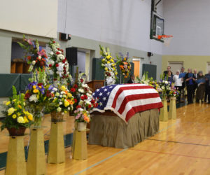 Flowers surround Roy Farmer's flag-draped casket during a memorial service at the Wiscasset Community Center on Sunday, April 7. Farmer, a local businessman and public servant for many years, died March 26 at the age of 91. (Charlotte Boynton photo)