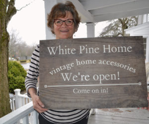 Betsy Kyle holds the sign she will soon mount on her home at 57 Washington St. to welcome customers to her new business, White Pine Home. (Charlotte Boynton photo)