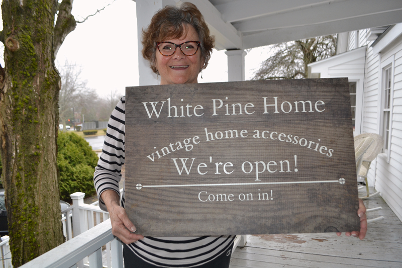 Betsy Kyle holds the sign she will soon mount on her home at 57 Washington St. to welcome customers to her new business, White Pine Home. (Charlotte Boynton photo)