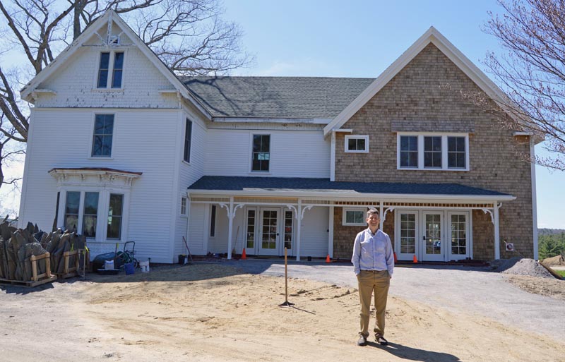 Coastal Rivers Conservation Trust Executive Director Steven Hufnagel stands in front of the newly renovated Rafter family farmhouse, the trust's new headquarters at Round Top Farm in Damariscotta. (Evan Houk photo)