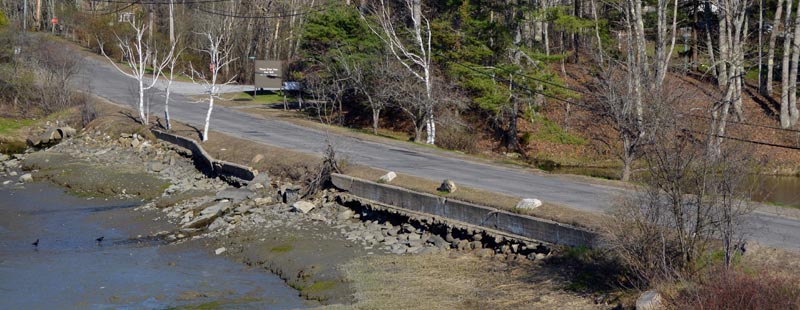 A view of Miles Street in Damariscotta from the parking lot at LincolnHealth's Miles Campus. The town of Damariscotta and LincolnHealth will split the cost to rebuild the street, build a new sidewalk, and rebuild the retaining wall. (Evan Houk photo)