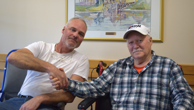 From left: David Reiss shakes hands with David Drever weeks after rescuing Drever from the cold waters of Damariscotta Lake on April 22. (Jessica Clifford photo)