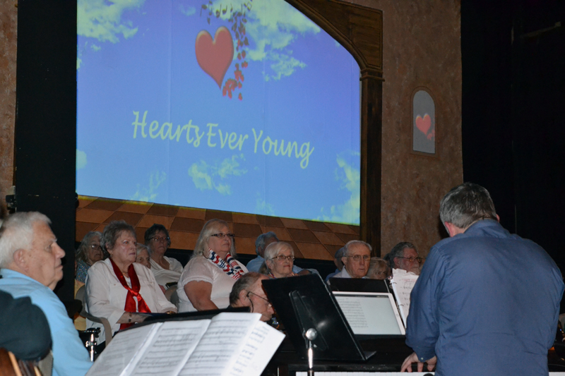 Hearts Ever Young musical director Sean Fleming (right, with back to camera) plays the piano and leads the band in the opening number of Hearts Ever Young's packed matinee show on the afternoon of Monday, May 20. (Christine LaPado-Breglia photo)