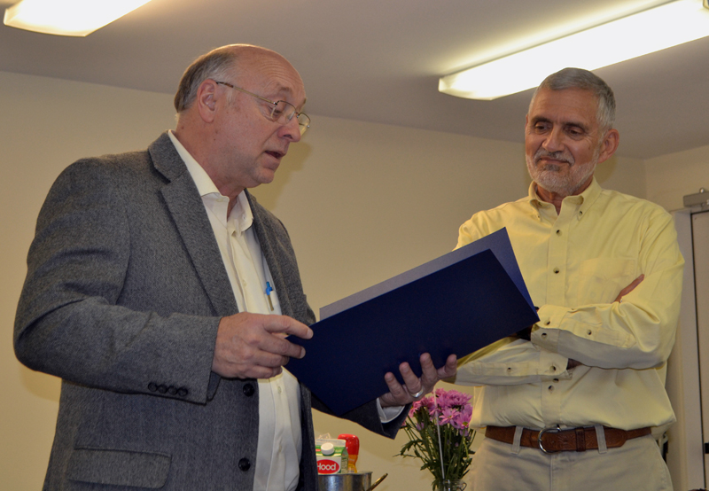 State Sen. Dana Dow (left) reads a legislative sentiment to Lincoln County Planner Bob Faunce during Faunce's retirement party at the Lincoln County Regional Planning Commission in Wiscasset on May 15. (Charlotte Boynton photo)