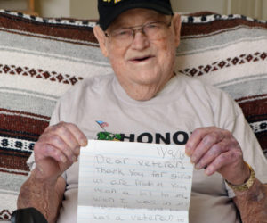 World War II veteran Eugene Walsh, 102, of Newcastle, holds a letter from a student thanking him for his service. He received the letter upon his return from an Honor Flight Maine trip to Washington, D.C. (Charlotte Boynton photo)
