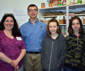 From left: Sarah Skovran, of the Area Interfaith Outreach Food Pantry; Jared Grenier, FoodCorps service member; and Medomak Middle School seventh graders Lillian Peirce and Angel Grierson inside Medomak Middle School's Community Market. (Alexander Violo photo)